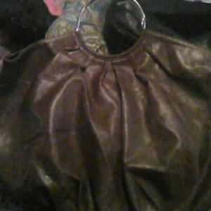 A brown leather hobo style purse